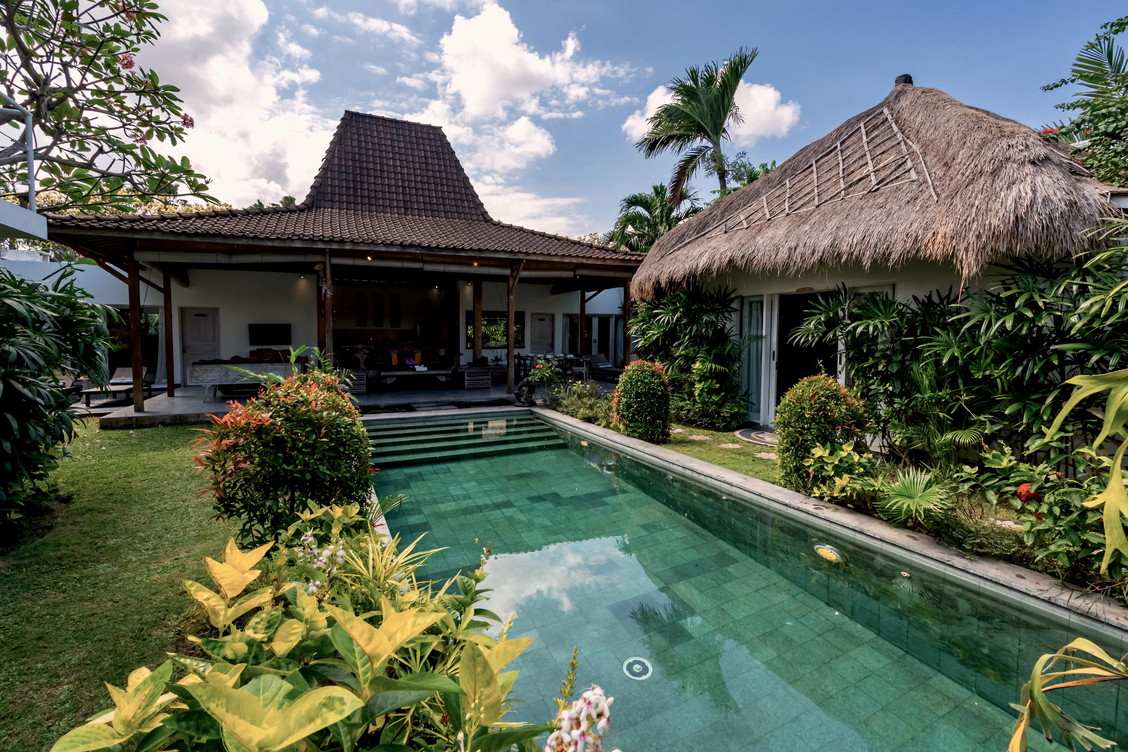 The pool with the open living pavilion and the bale beyond